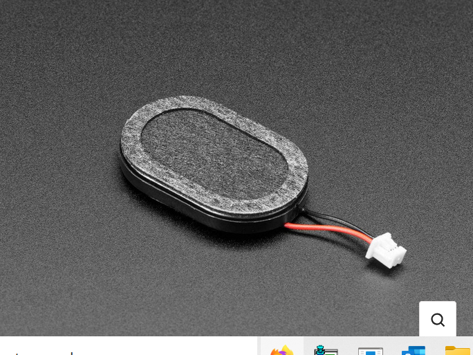 The little oval speaker, trailing red and black wires.